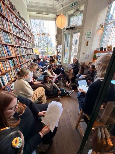 Bookless Bookclub members reading and discussing in Tills Bookshop, Edinburgh